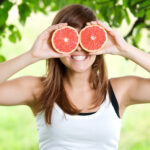young woman having fun with fruits