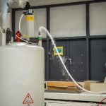scientist adding liquid nitrogen to the nmr nuclear magnetic resonance